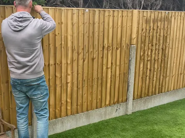 Freshly installed close-board fence panels with concrete posts on a residential garden