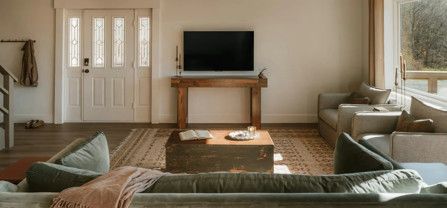 A bright, cosy living room with a neatly wall-mounted television